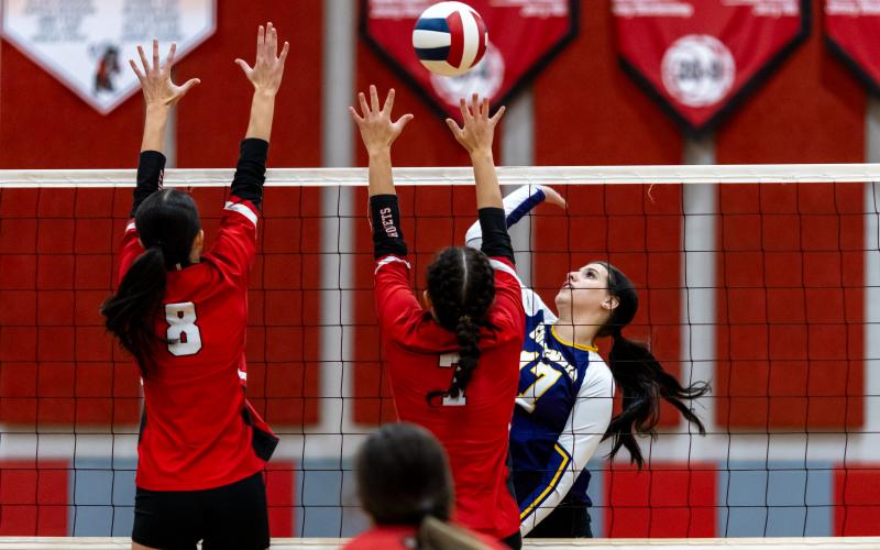 Columbia hitter Kayla Goodloe fires a shot at Lafayette's Kiley Beach (8) and Libby Beach (7) on Sept. 24. (JACK HOWDESHELL/Lake City Reporter)
