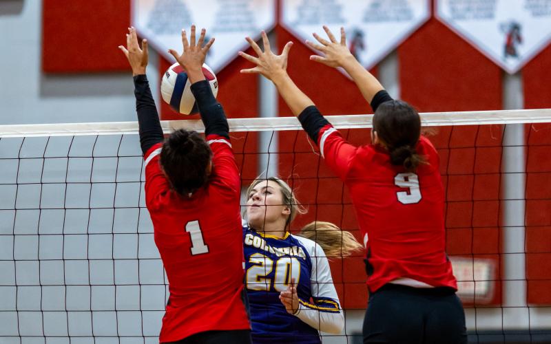 Columbia middle hitter Cassidy O'Neal fires a shot at Lafayette's Brooke Lamb (1) and Sophia Kendrick (9) on Sept. 24. (JACK HOWDESHELL/Lake City Reporter)