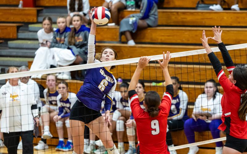 Columbia hitter Sinei Wood (6) fires a shot toward Lafayette middle blocker Sophia Kendrick (9) and hitter Rylee Skillman (right) on Sept. 24. (JACK HOWDESHELL/Lake City Reporter)