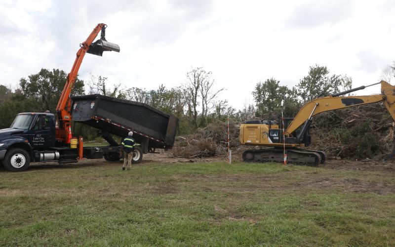 A Lake City Public Works truck gets set to dump debris onto an existing pile at the Public Works lot on NE Gum Swamp Road Friday afternoon. (MORGAN MCMULLEN/Lake City reporter)