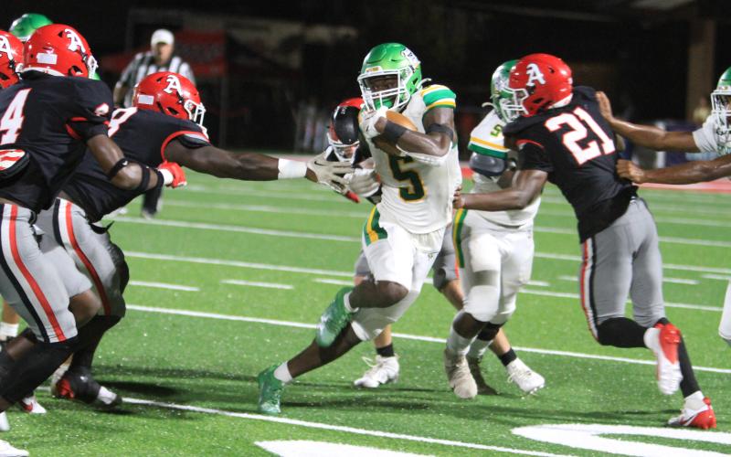 Suwannee receiver MJ Rossin tries to avoid Appling County tacklers as he runs up the field on Sept. 20. (PAUL BUCHANAN/Lake City Reporter)