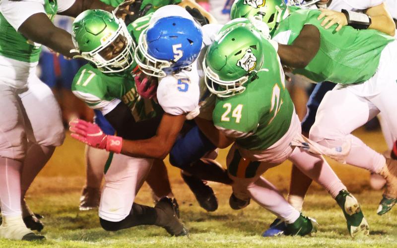 Suwannee linebacker Travis Fead (17) and defensive end Kyler Watson (24) tackle Taylor County running back Dj McCoy last Friday. (PAUL BUCHANAN/Lake City Reporter)