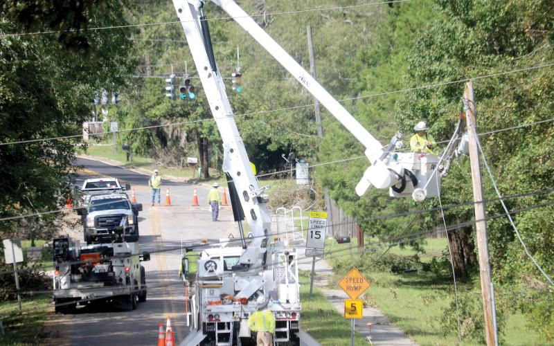 Linemen work on a power pole on SW Grandview Street in Lake City on Monday as utility crews continue to try to get power back to residents following Hurricane Helene. (TONY BRITT/Lake City Reporter)