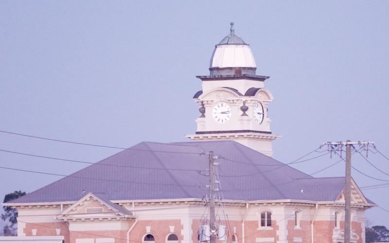 The Suwannee County Courthouse was damaged by Hurricane Helene last month with two of the four clock faces knocked out and copper peeled off the dome. Temporary repairs have been done to the dome and the renovation work received a donation this week from the Sons of the American Revolution’s Lake City chapter. (JAMIE WACHTER/Lake City Reporter)