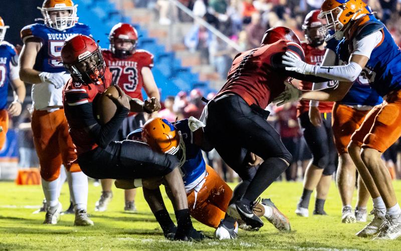 Lafayette quarterback Tywan Williamson fights for extra yardage against Branford on Monday. (JACK HOWDESHELL/Lake City Reporter)
