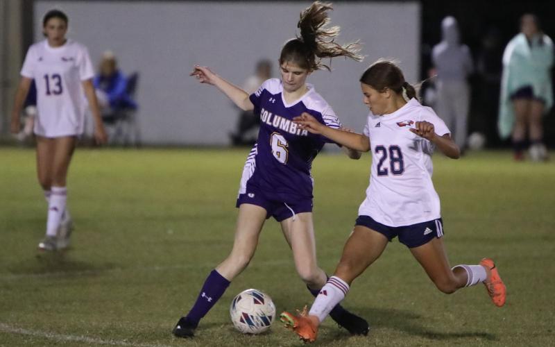 Columbia's Niki Sossie dribbles while defended by Wakulla's Hadley Brown on Thursday night. (BRENT KUYKENDALL/Lake City Reporter)