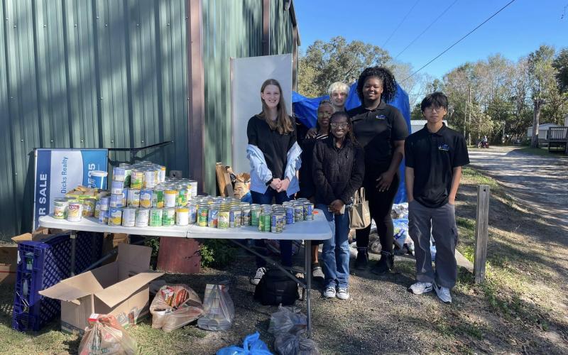 Students with the Columbia High FBLA program helped pass out food this past weekend with the Kids Feeding Kids Thanksgiving program. (COURTESY)