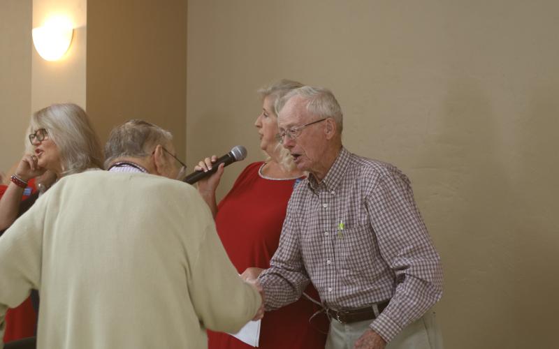 Donald Christensen (right) shakes hands with Kenneth Keen as the pair were among four veterans honored during Saturday’s annual veterans luncheon at the Florida Gateway Fairgrounds for being the oldest in attendance. Keen is 93 and Christensen is 94. Also recognized were Edward Fries, 93, and Wayne Morrell, 100. (TONY BRITT/Lake City Reporter)