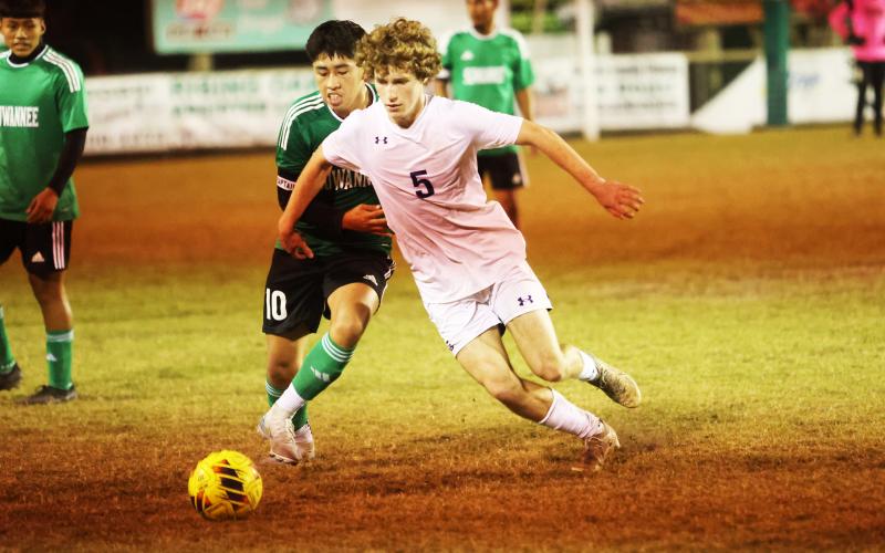 Columbia’s Nathan Matsubara (5) dribbles past Suwannee’s Denzel Yaxon (10) during Monday’s match. (PAUL BUCHANAN/Lake City Reporter)