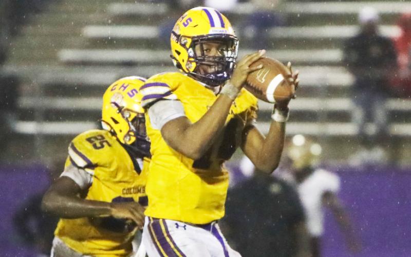 Columbia quarterback Xavier Collins gathers a snap in the rain during the Tigers’ contest against St. Augustine on Sept. 25. (BRENT KUYKENDALL/Lake City Reporter)