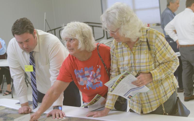 Justin Fairman (from left), an FDOT employee, listens as Elaine Reeves and Jeanette Lee share their concerns about congested traffic patterns in the Ellisville area near Intestate 75 on Monday afternoon. (TONY BRITT/Lake City Reporter)