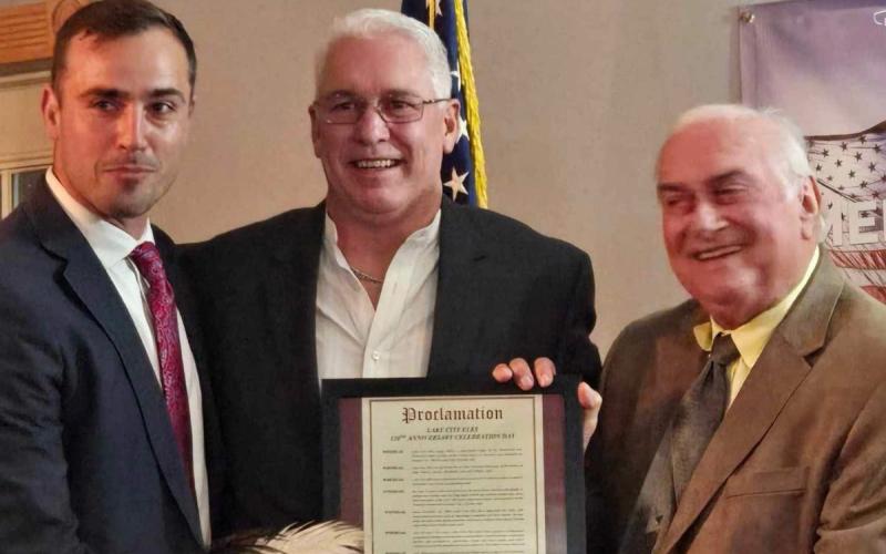 Lake City Elks Lodge 893 members Noah Walker (from left), Exalted Ruler Bill Roberts and Stephen Witt show off a proclamation declaring Nov. 9, 2024, as Lake City Elks Lodge 893 Anniversary Celebration Day. The lodge held a celebration on Saturday night acknowledging 120 years of providing service to Columbia County. (COURTESY)