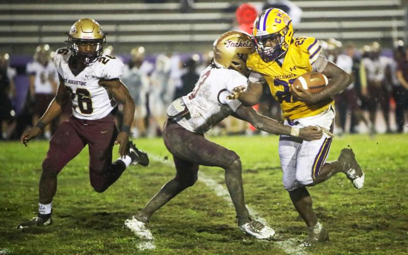 Columbia running back Jerome Horne fights through a tackle from St. Augustine defensive back Braylon James on Sept. 25. (BRENT KUYKENDALL/Lake City Reporter)