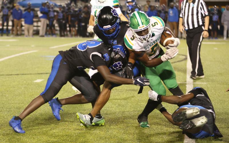 Suwannee receiver MJ Rossin is stood up by a trio of Godby defenders Friday night in a Region 1-3A quarterfinal at Gene Cox Stadium. (PAUL BUCHANAN/Lake City Reporter)