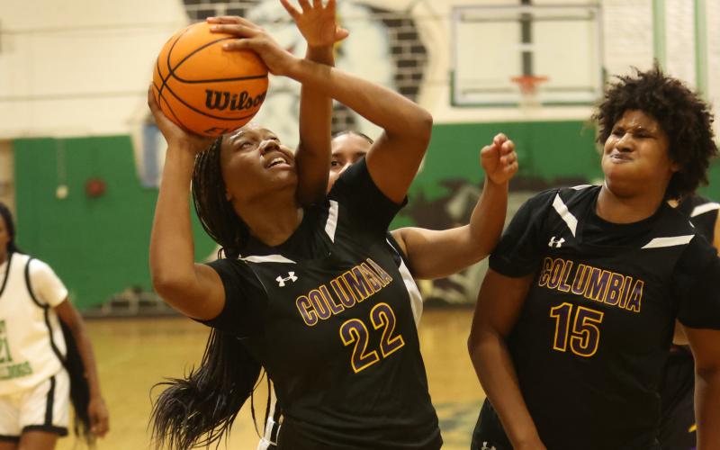 Columbia forward Dariyan Williams (22) tries to get off a shot against Suwannee on Friday. (PAUL BUCHANAN/Lake City Reporter)