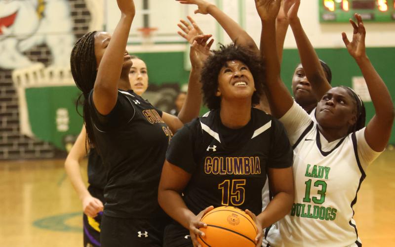 Columbia forward Jolena Gardner grabs a rebound in traffic during Friday’s game against Suwannee. (PAUL BUCHANAN/Lake City Reporter)