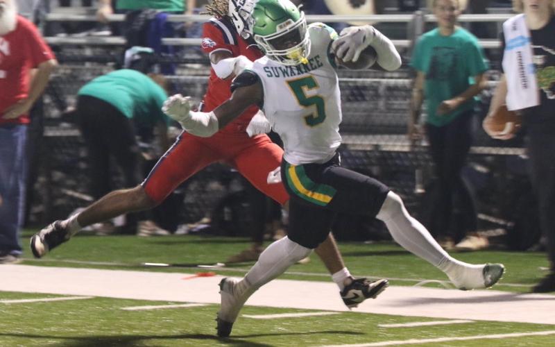 Suwannee receiver MJ Rossin evades a Wakulla defender on his way to the end zone for a touchdown in the first quarter of Thursday’s game. (MORGAN MCMULLEN/Lake City Reporter)