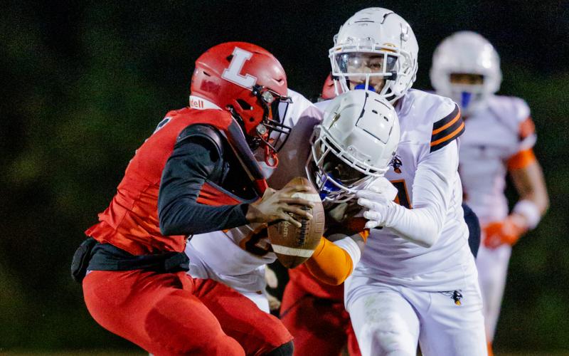 Lafayette quarterback Tywan Williamson is sacked by Hawthorne defensive tackle Kyler Ingram during the Class Rural quarterfinals on Friday. (JACK HOWDESHELL/Lake City Reporter)
