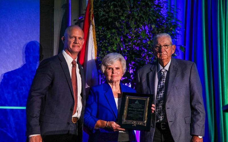 Rod (right) and Brenda Gayle Land were presented the 2024 Distinguished Service Award by Florida Farm Bureau President Jeb S. Smith at the organization’s state annual meeting. (COURTESY)