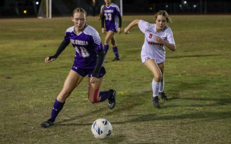 Columbia's Jenavieve Farer and Lafayette's Mya Pilkington chase after possession of the ball on Monday night. (BRENT KUYKENDALL/Lake City Reporter)