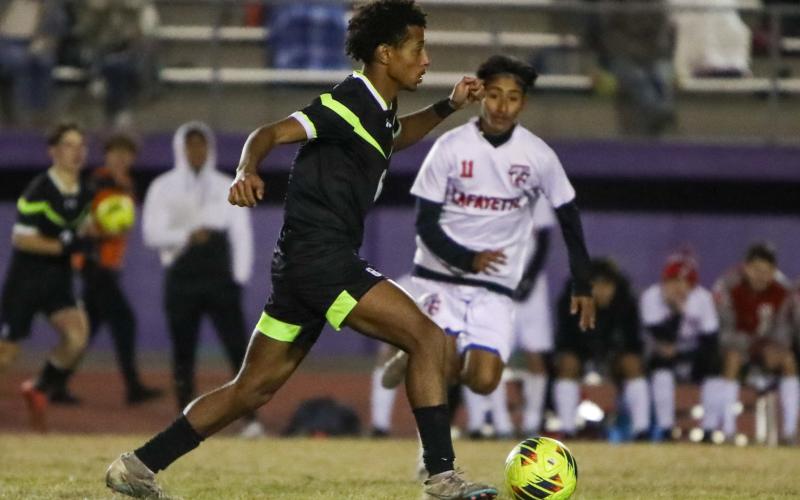 Columbia's Cayden Weatherspoon dribbles up the field against Lafayette on Monday. (BRENT KUYKENDALL/Lake City Reporter)