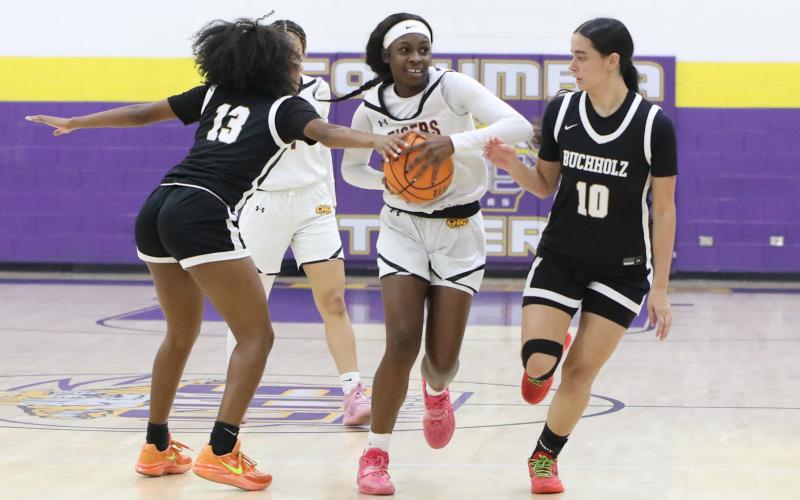 Columbia guard Ayesha Broxey tries to pass out of a double team from Buchholz guards Kennedy Wyckoff (13) and Isabella Alexander (10) on Wednesday night. (BRENT KUYKENDALL/Lake City Reporter)