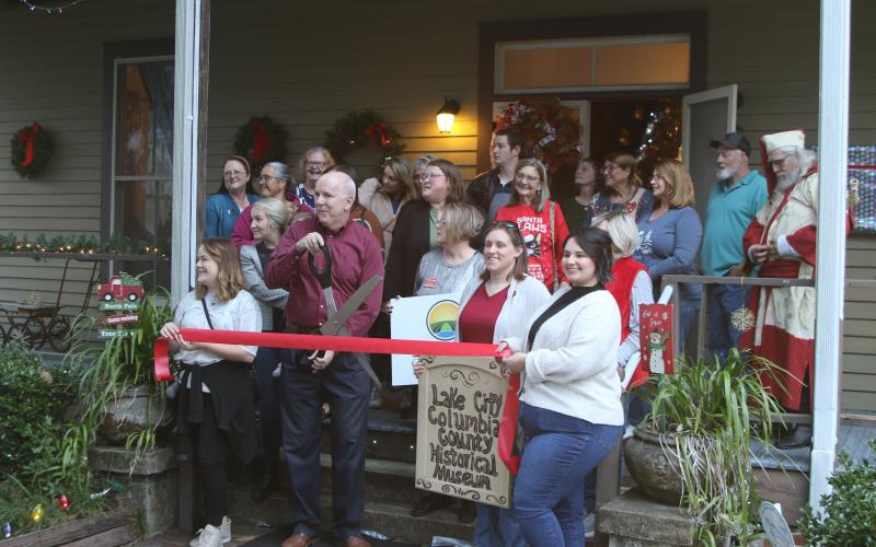 Members of the Lake City-Columbia County Historical Museum prep to cut the ribbon during the museum’s grand re-opening event Thursday. (TONY BRITT/Lake City Reporter)