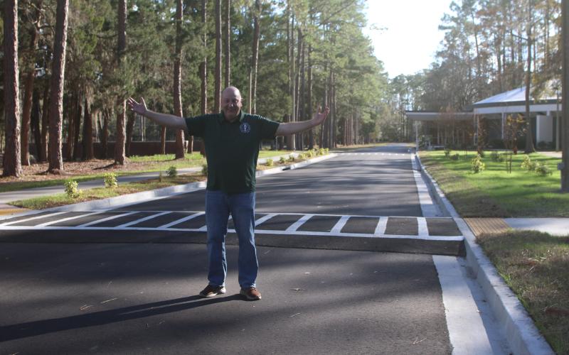 Florida Gateway College President Larry Barrett stands on the finished roadway on the college campus that runs past the Howard Center. The road was opened a few weeks ago. (TONY BRITT/Lake City Reporter)