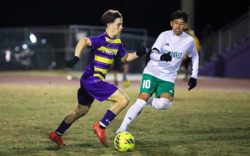 Columbia's Cody Bass dribbles up the field past Suwannee's Denzel Yaxon on Wednesday night. (BRENT KUYKENDALL/Lake City Reporter)