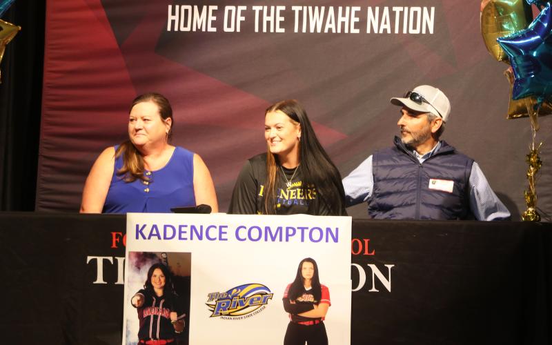 Fort White softball pitcher Kadence Compton (middle) smiles during her signing ceremony Wednesday alongside his mother, Lora, and her father, Paul. Compton signed her letter of intent to play collegiately at Indian River State College. (MORGAN MCMULLEN/Lake City Reporter)