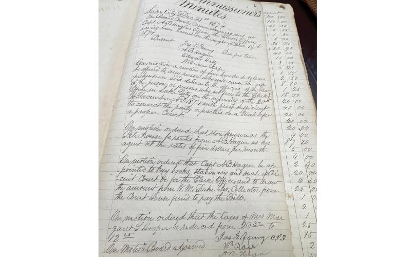 Minutes from the Dec. 21, 1874, Columbia County Commission meeting show the county offered a $5,000 reward for the capture and conviction of whoever burned down the courthouse the previeous day. Nobody was ever charged with the crime. (JAMIE WACHTER/Lake City Reporter)