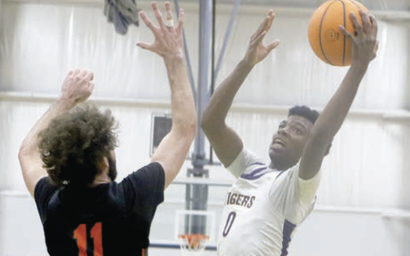 Columbia guard Murkail Cray goes up for a shot over Trenton’s Nathan Ridgell during Friday's game at the Hitchcock’s Challenge. (MORGAN MCMULLEN/Lake City Reporter)
