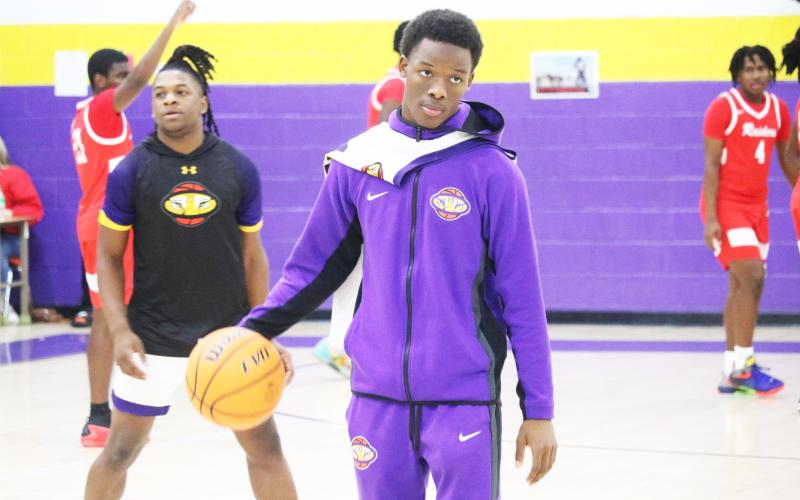 Columbia guard Marlin Haywood helps the Tigers warm up prior to Friday’s game against Santa Fe. Haywood has transferred back to Columbia after playing football at Bradford this fall. (JORDAN KROEGER/Lake City Reporter)