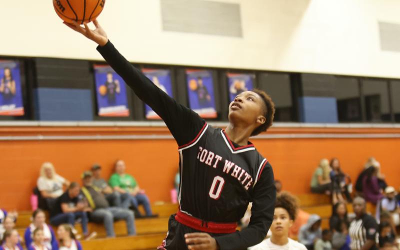 Fort White forward Isreal Hart makes a layup against Branford on Tuesday night. (PAUL BUCHANAN/Lake City Reporter)