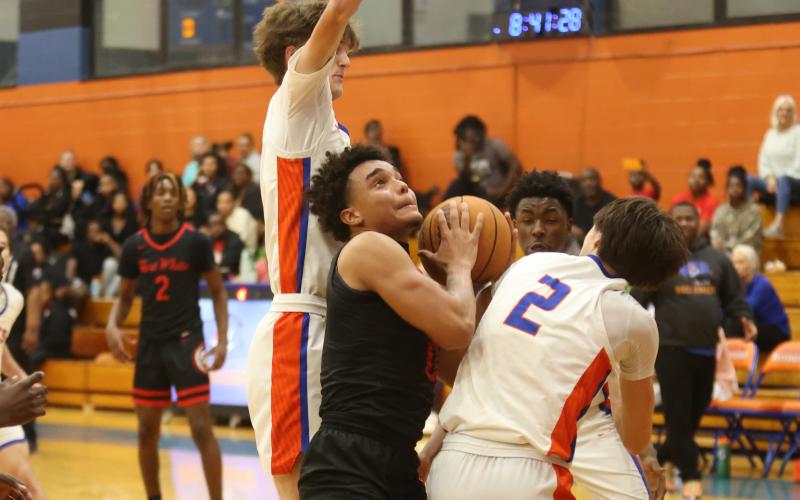 Fort White guard Tafari Moe fights to get off a shot amid the Branford defense on Tuesday night. (PAUL BUCHANAN/Lake City Reporter)