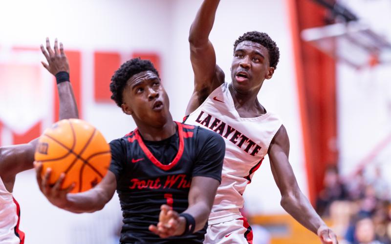 Fort White guard Jayden Jackson drives for a shot as Lafayette guard Jordan Murphy defends Thursday night. Jackson scored 24 points to lead the Indians to a 61-33 win. (JACK HOWDESHELL/Lake City Reporter)