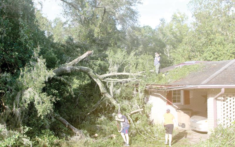 Columbia County residents survey the damage to a home in the wake of Hurricane Helene. Helene made landfall on Sept. 26 before knocking out power for more than 99% of Columbia County residents. (FILE)