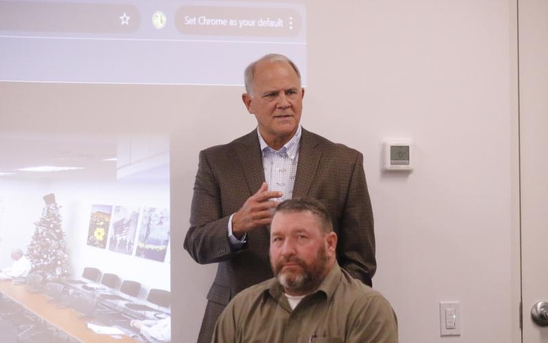 Former State Rep. Bobby Payne (top) speaks during the NFWUA meeting Wednesday in front of Leo Mobley, a board member. (JAMIE WACHTER/Lake City Reporter)