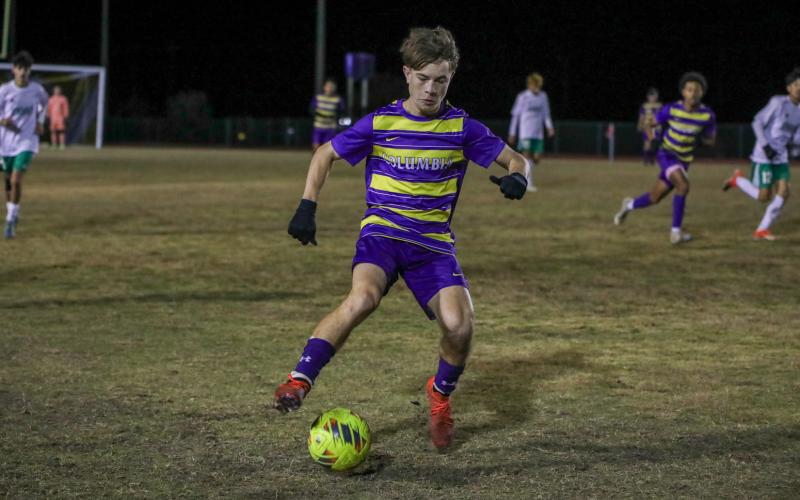 Columbia's Cody Bass dribbles up the field against Suwannee on Dec. 11. (BRENT KUYKENDALL/Lake City Reporter)