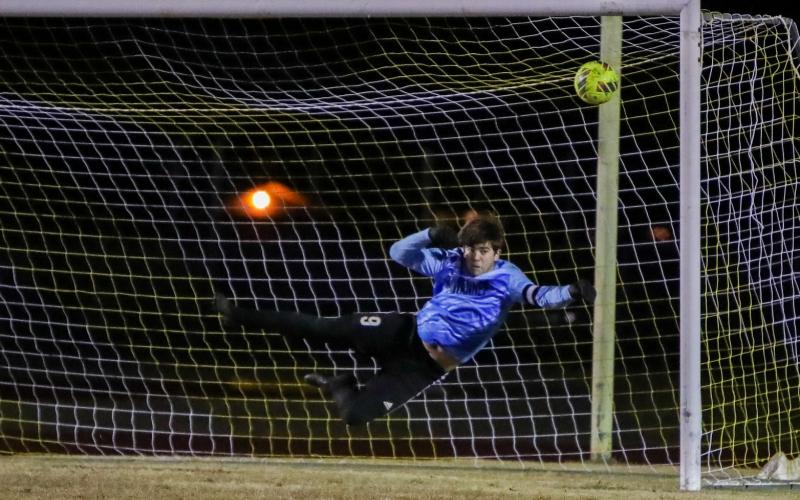 Suwannee goalkeeper AJ Hitt dives to try and save a shot against Columbia on Dec. 11. (BRENT KUYKENDALL/Lake City Reporter)
