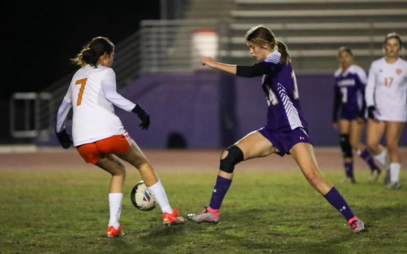 Columbia's Mia Brasel tries to dribble past Orange Park's Heily Davila on Jan. 9. (BRENT KUYKENDALL/Lake City Reporter)