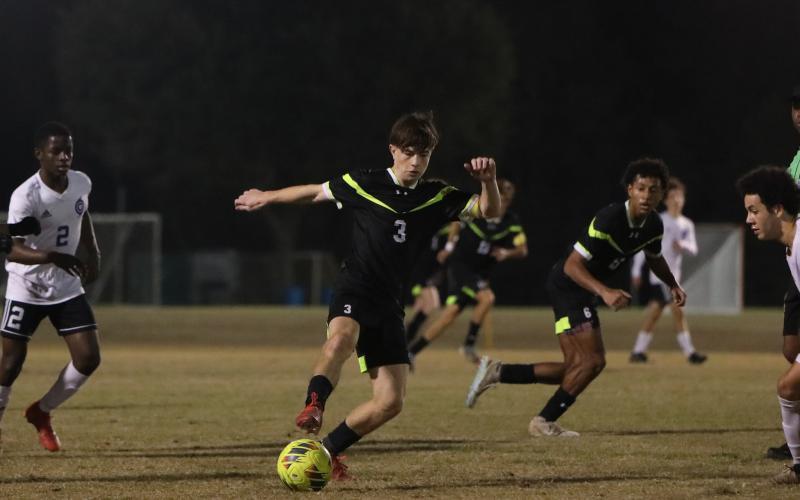 Columbia's Cody Bass dribbles the ball up the field against Gainesville on Jan. 10. (BRENT KUYKENDALL/Lake City Reporter)