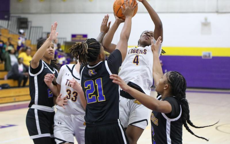 Columbia guard Eriel Baker shoots while defended by Rickards forward Jariyah Jordan (21) and guard Lauryn Pye (3) on Thursday night. (BRENT KUYKENDALL/Lake City Reporter)