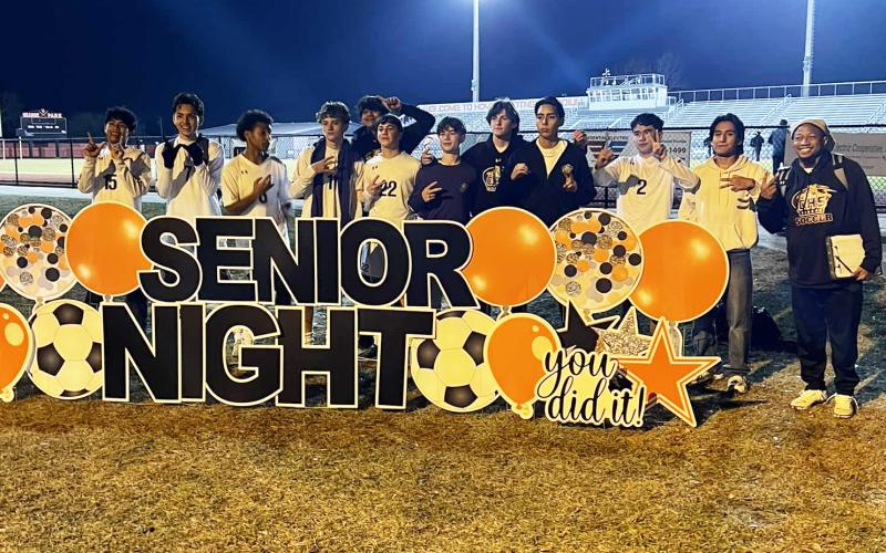 Columbia’s boys soccer team poses with Orange Park’s Senior Night sign after defeating the Raiders 2-0 on Friday. (COURTESY)