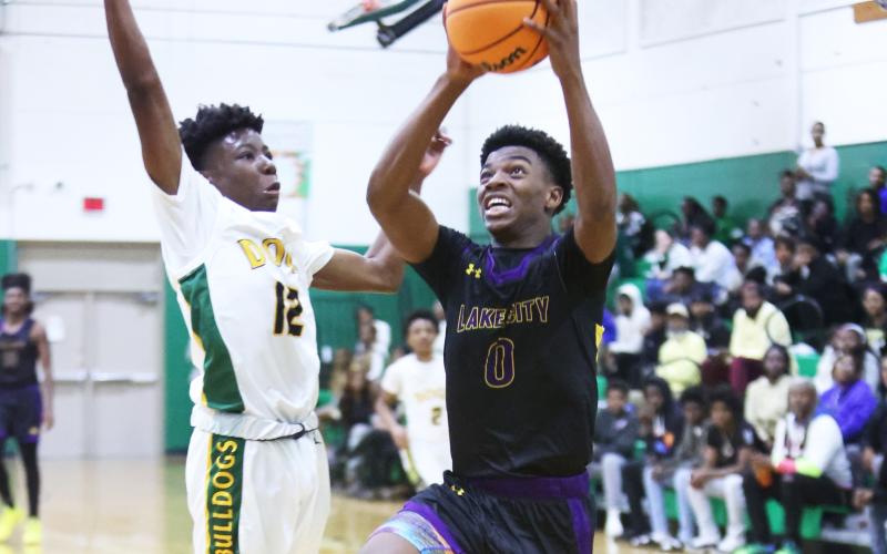 Columbia guard Murkail Cray drives to the basket while defended by Suwannee guard Khy Smith on Friday. (PAUL BUCHANAN/Lake City Reporter)