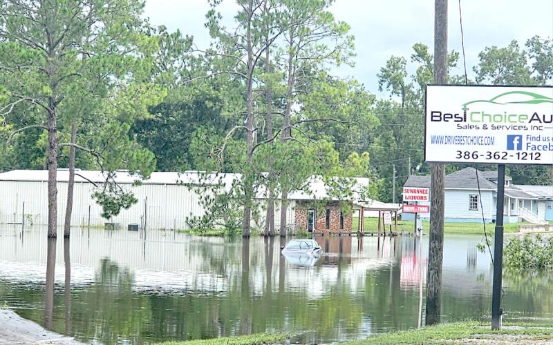 A car sits submerged in flood waters on Ohio Avenue (U.S. Highway 129) in Live Oak following Hurricane Debby in August. (FILE)