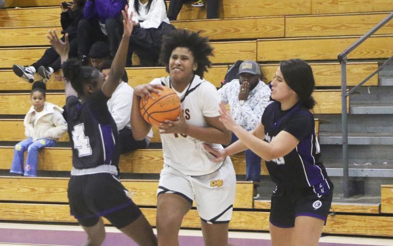 Columbia forward Jolena Gardner tries to split a pair of Gainesville defenders Friday night. (MORGAN MCMULLEN/Lake City Reporter)