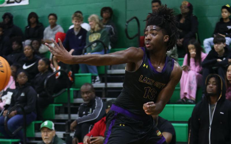 Columbia forward Zavian Douglas saves the ball from going out of bounds during Friday's game against Suwannee. (PAUL BUCHANAN/Lake City Reporter)