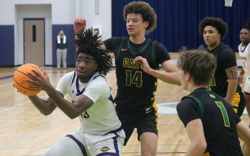 Columbia forward Zavian Douglas gathers the ball to shoot against Forest in the Hitchcock's Challenge championship on Dec. 29. (JORDAN KROEGER/Lake City Reporter)