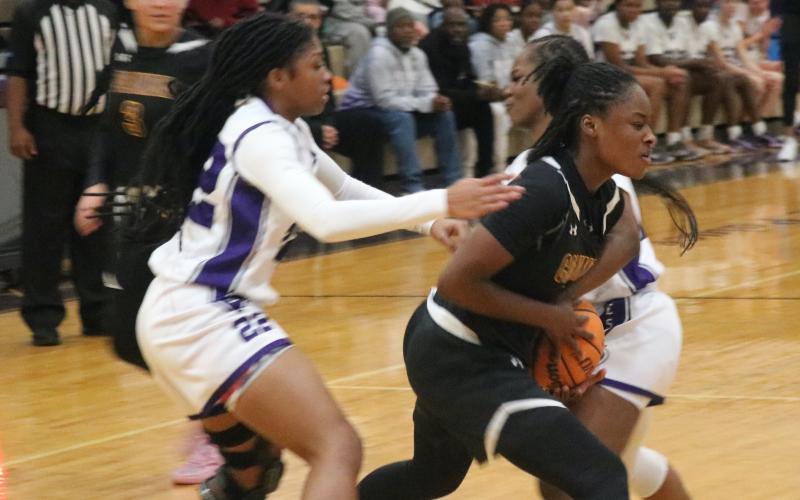 Columbia guard Eriel Baker is double teamed by Gainesville's Mayah Gordon (22) and Lady Taylor during Tuesday night's 53-27 loss. (JORDAN KROEGER/Lake City Reporter)